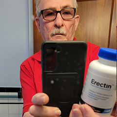 Customer Holding Erectin Bottle